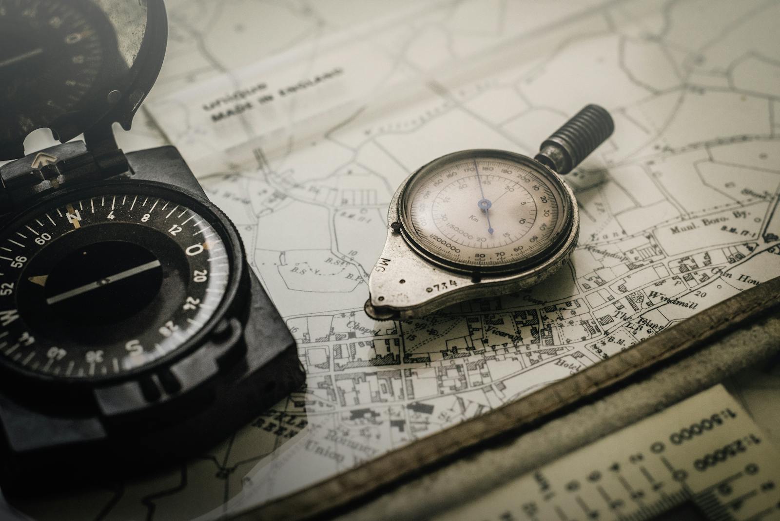 A vintage compass and navigation instrument on an old map as a symbol for finding your mission in a corporate world