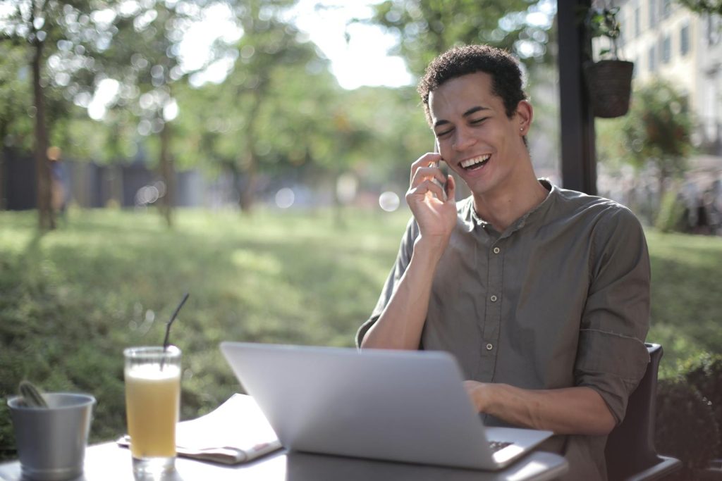 Solo entrepreneur happily talking with one of his customers after he decided to no longer pursue corporate comfort.
