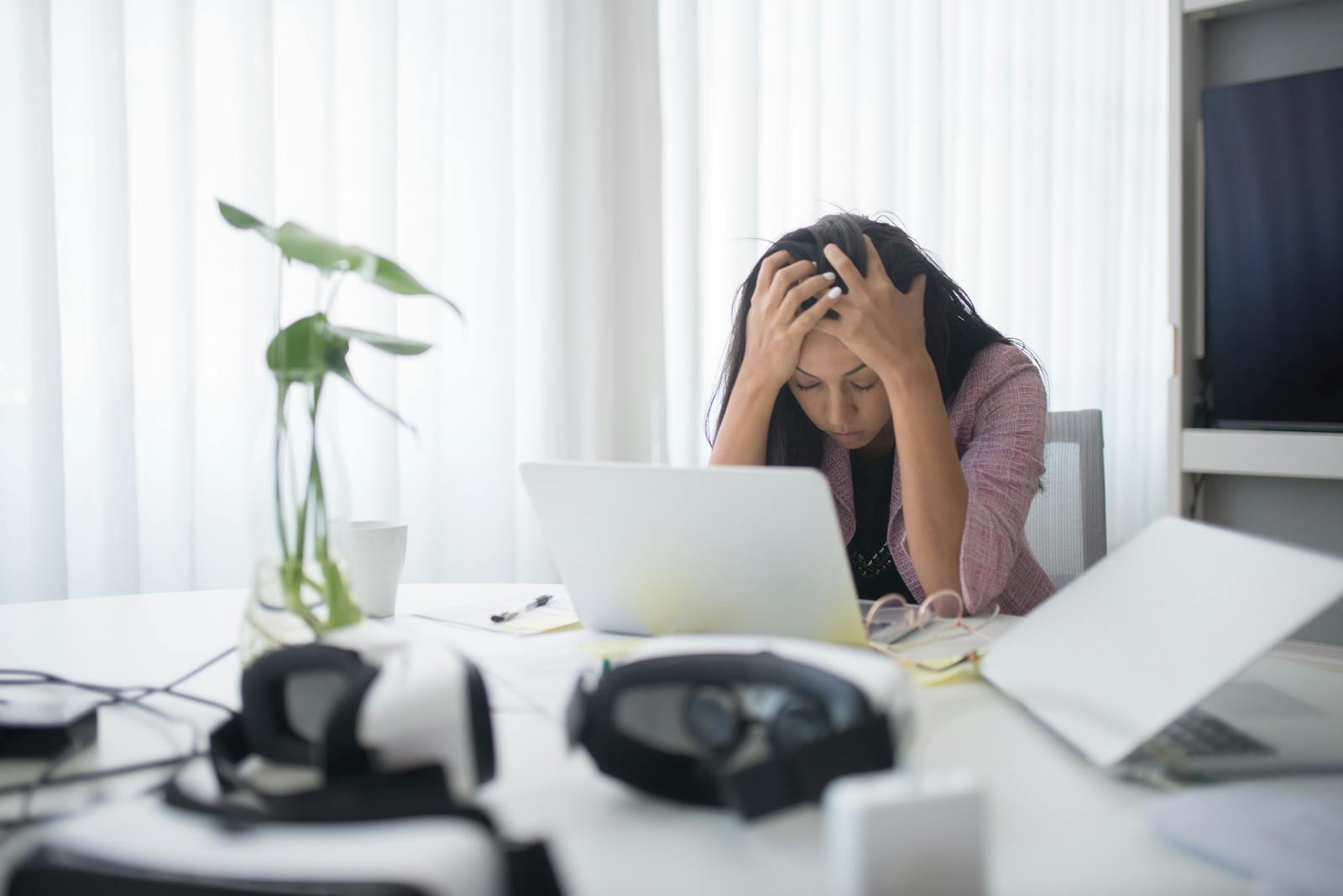 Frustrated woman sitting at desk with laptop, leaving corporate job
