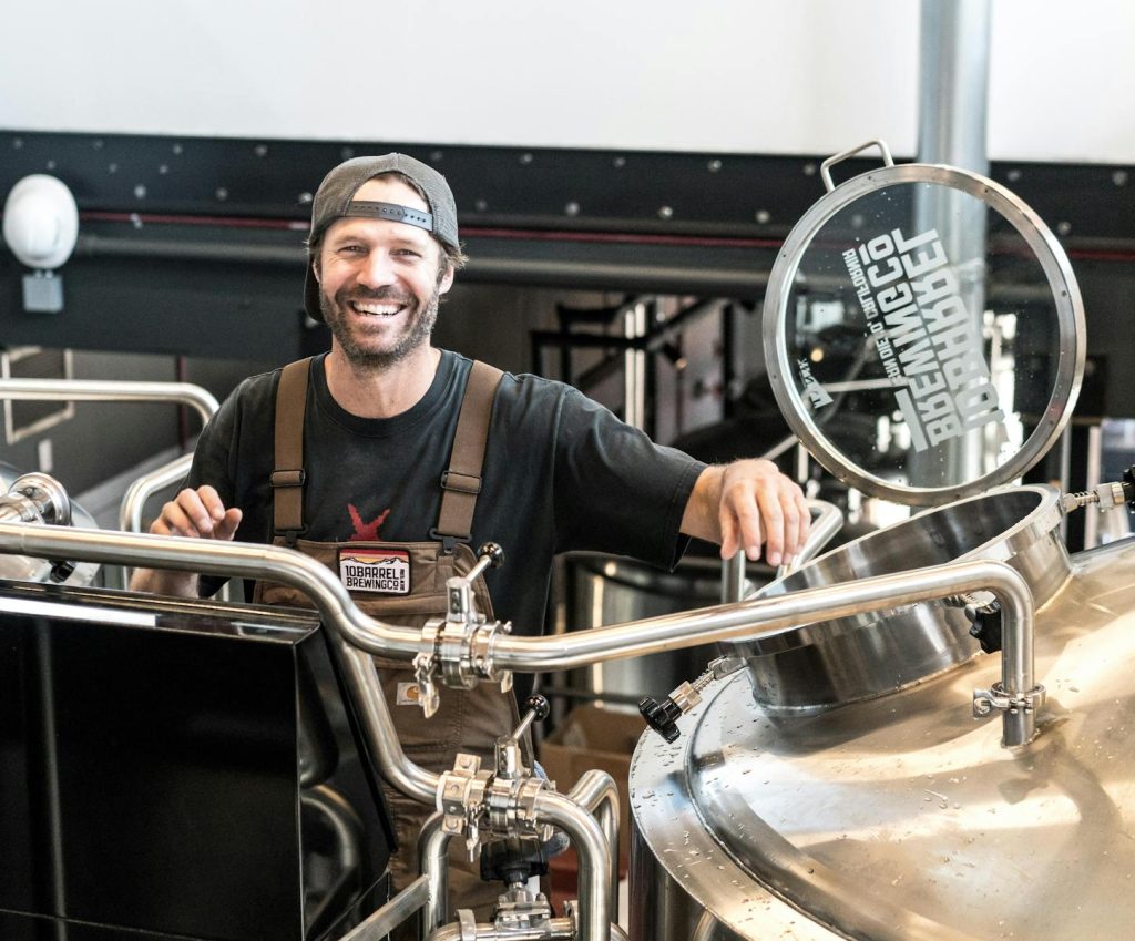 Happy brewer in a craft brewery after he quit corporate job.